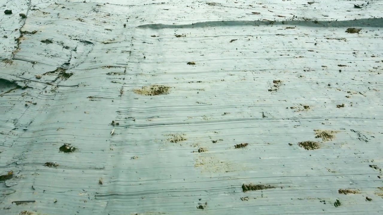 Detail of dry solid farm field seasonal environmental erosion. Aerial drone view over clay surface farming agriculture.