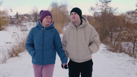 couple walking hand-in-hand in winter park