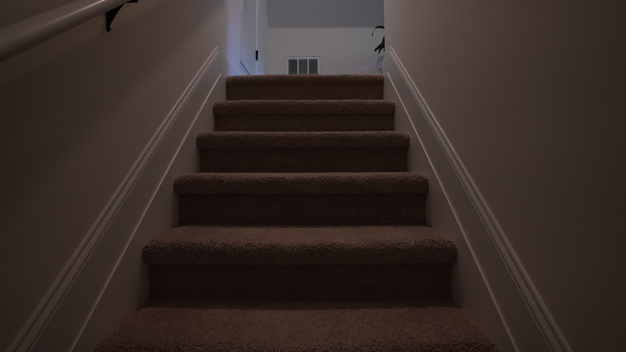 Walking up the carpet stairs in a house, dangerous, fall
