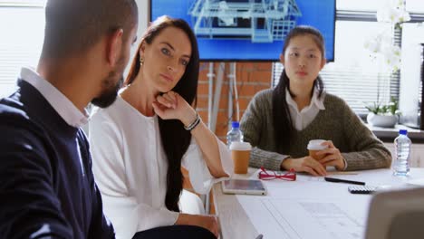 Business-colleagues-discussing-over-laptop-in-conference-room-4k