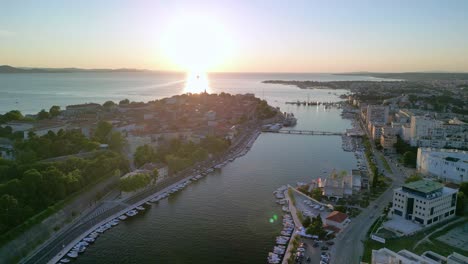 An-aerial-over-part-of-Zadar-town,-obala-Kneza-Branimira,-Jazine-marina-and-peninsula-in-sunset