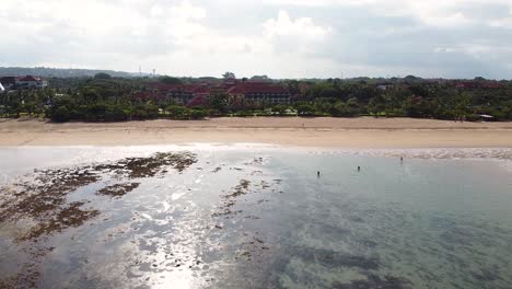 Aerial---beautiful-drone-shot-of-beach-front-hotel-in-Nusa-Dua,-Bali