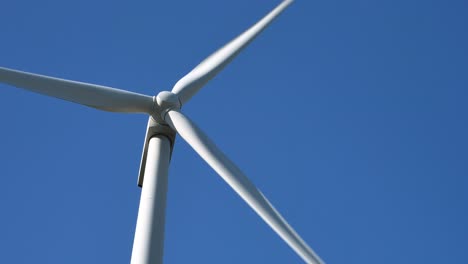Low-shot-of-a-rotated-wind-turbine-against-a-blue-sky