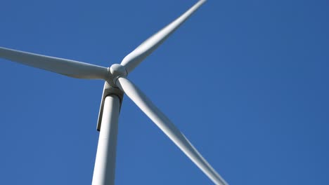 low shot of a rotated wind turbine against a blue sky