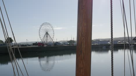 part of boat sail and ferris wheel by the day at the edge of the port old famous normandy and france landmark