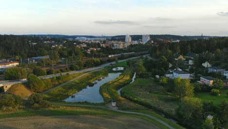 drone shot over pound, field and railway in upplands väsby, sweden