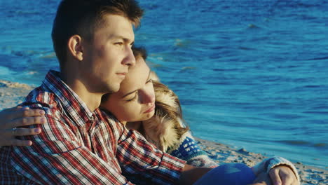 Romantic-Couple-Relaxing-On-The-Beach-She-Clung-To-The-Guy-Sunny-And-Windy-Day-In-Autumn