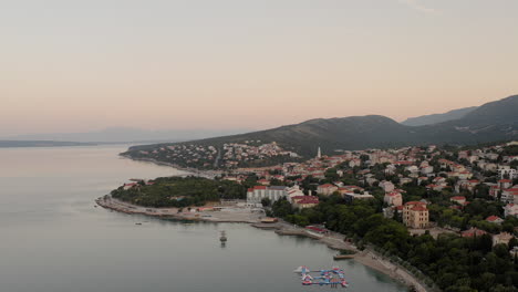 panoramic view of a coastal town in croatia, adriatic coastline, rocky beaches, sunrise, seaside homes, balkan summer vacation, holiday destination, mediterranean landscape, pristine waters, tourism