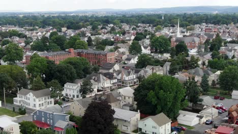 aerial establishing shot of small town rural america, historic homes, colorful houses line street, summer time view of anytown usa, united states of america, friendly quiet neighborhood community