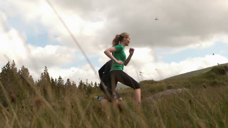 athletic couple jogging uphill