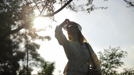 silhouette of a young beautiful girl wearing a hat at sunset and looking at the camera and smiling silhouette of a young beautiful girl wearing a hat at sunset and looking at the camera and smiling young woman posing on a sunny warm day