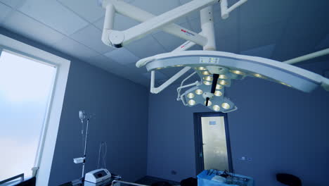 technological led lamps hanging in the surgical room. lamps giving bright light in the spot at operational table. empty operational room backdrop.