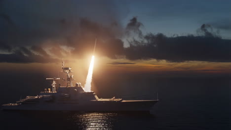 military ship launching a missile at sunset