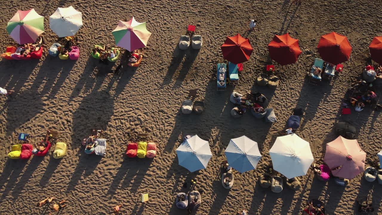 Beach Scene with People Relaxing Under Colorful Umbrellas