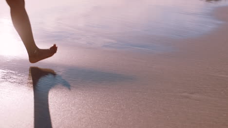 person walking on the beach at sunset