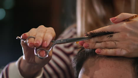 close-up hairdresser with scissors and comb. blurred background.