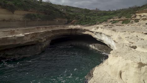 cave of st peter’s pool on cloudy stormy day with black clouds forming in sky