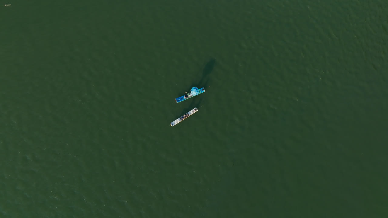 High angle drone shot rotating above rafts on the Li river, in Yangshuo, China