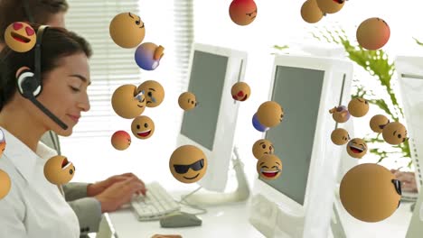 Animation-of-emoji-falling-over-business-people-wearing-phone-headsets