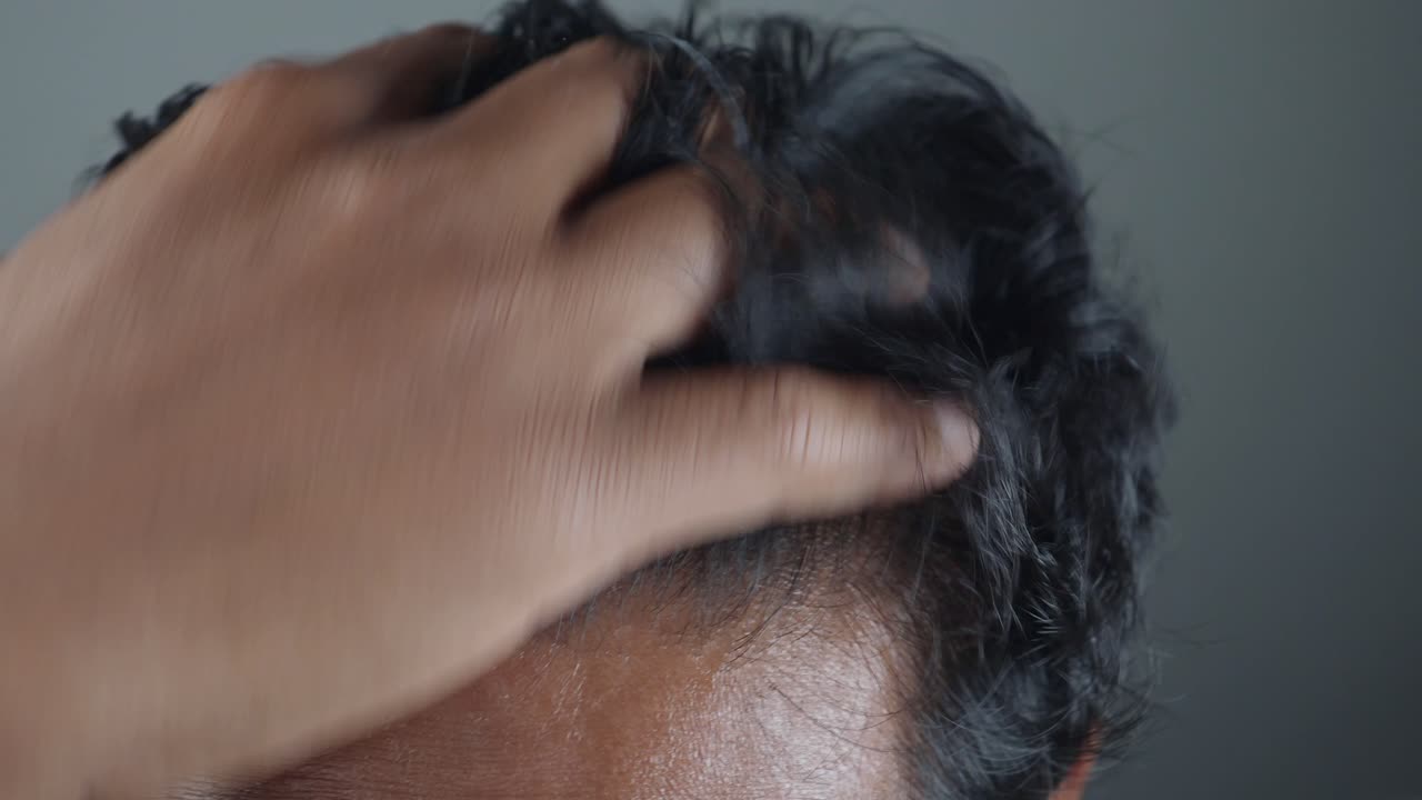Close-up of a man styling his hair