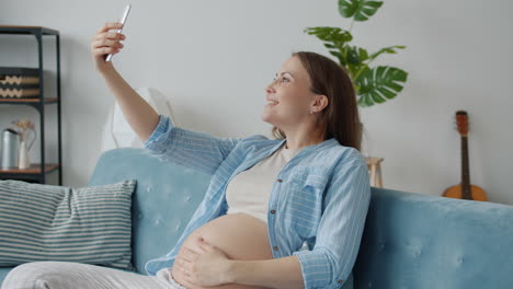 pregnant woman taking selfie