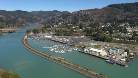 Aerial-circle-tilt-down-shot-of-Brookings-marina-on-sunny-day