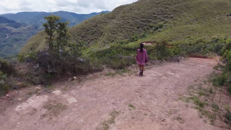 female tourist enjoys view from remote, rugged bolivian mountain road