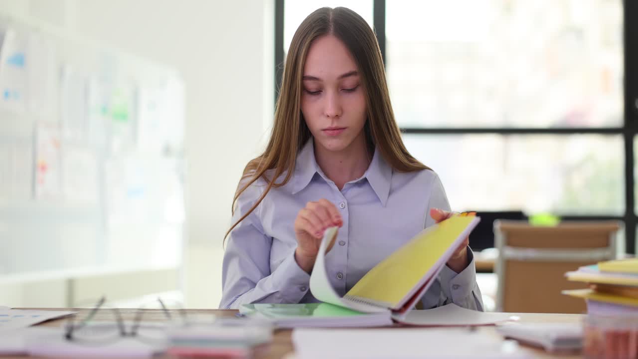 Focused Woman Working with Documents at an Office Desk