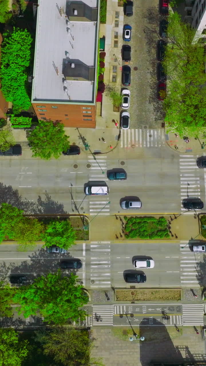 Cars driving quickly over the roads of busy city. New York city traffic. Aerial perspective. Vertical video