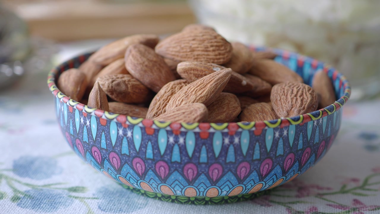 Close-Up of Raw Almonds in a Vibrant Patterned Bowl
