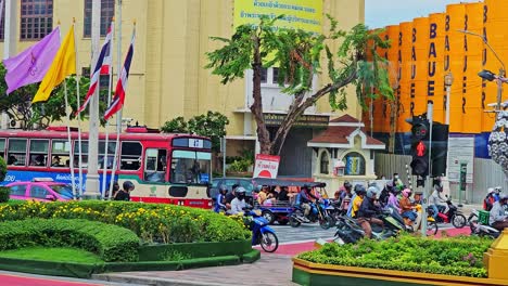 motor vehicles wait at a traffic light in bangkok, thailand.