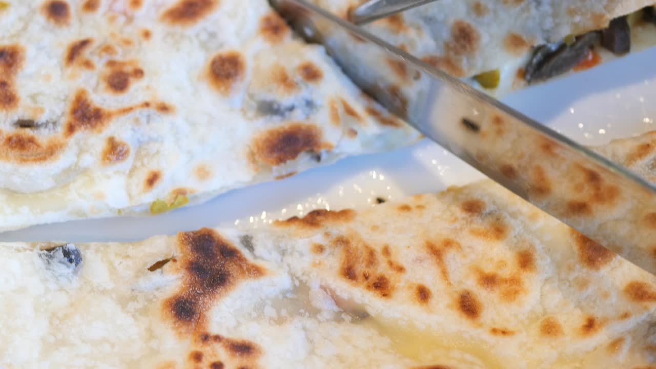Closeup of Stuffed Flatbread with Knife and Fork