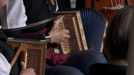 Elderly-musicians-playing-accordion-with-traditional-cloth