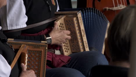 elderly musicians playing accordion with traditional cloth