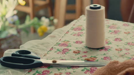 vintage sewing supplies on a floral table