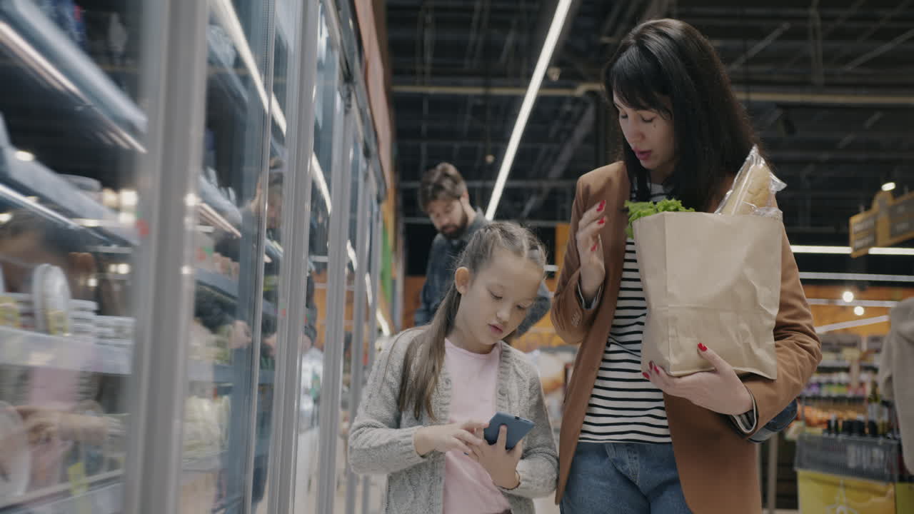 Mother and Daughter Shopping at the Grocery Store