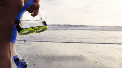 woman holding snorkel on the beach