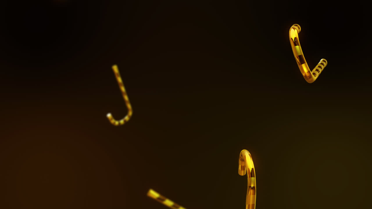 검은색 배경에 떨어지는 금색 사탕 막대기의 애니메이션.