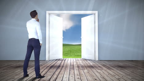 businessman watching door open to field