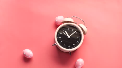 reloj despertador rosa con huevos de pascua
