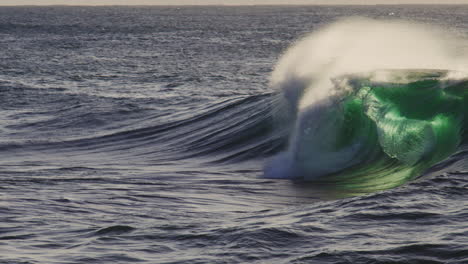 telephoto static natural backdrop of slow motion wave breaking with mist and spray rising off top