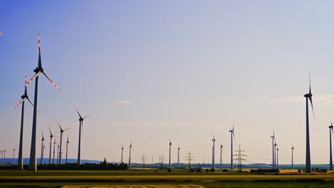 beautiful field with multiple wind turbines. wind farms at sunset. green energy concept.