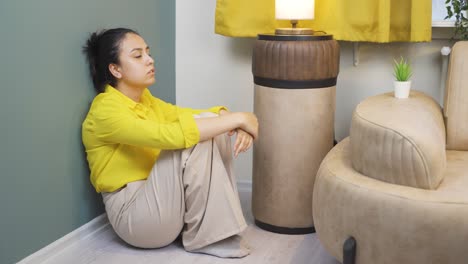 Depressed-young-woman.-It-sits-by-the-wall.