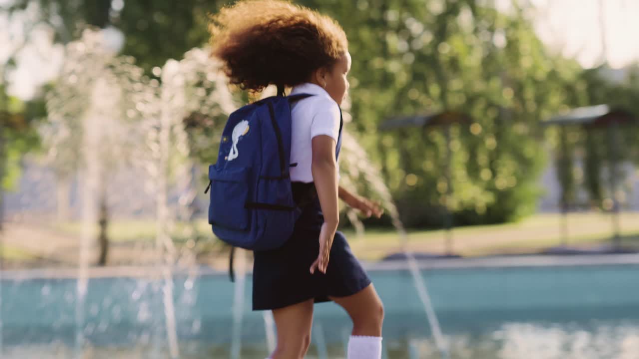 Student running by a fountain