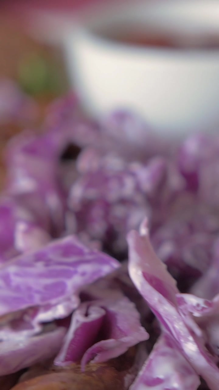 Eating sausages and red cabbage salad