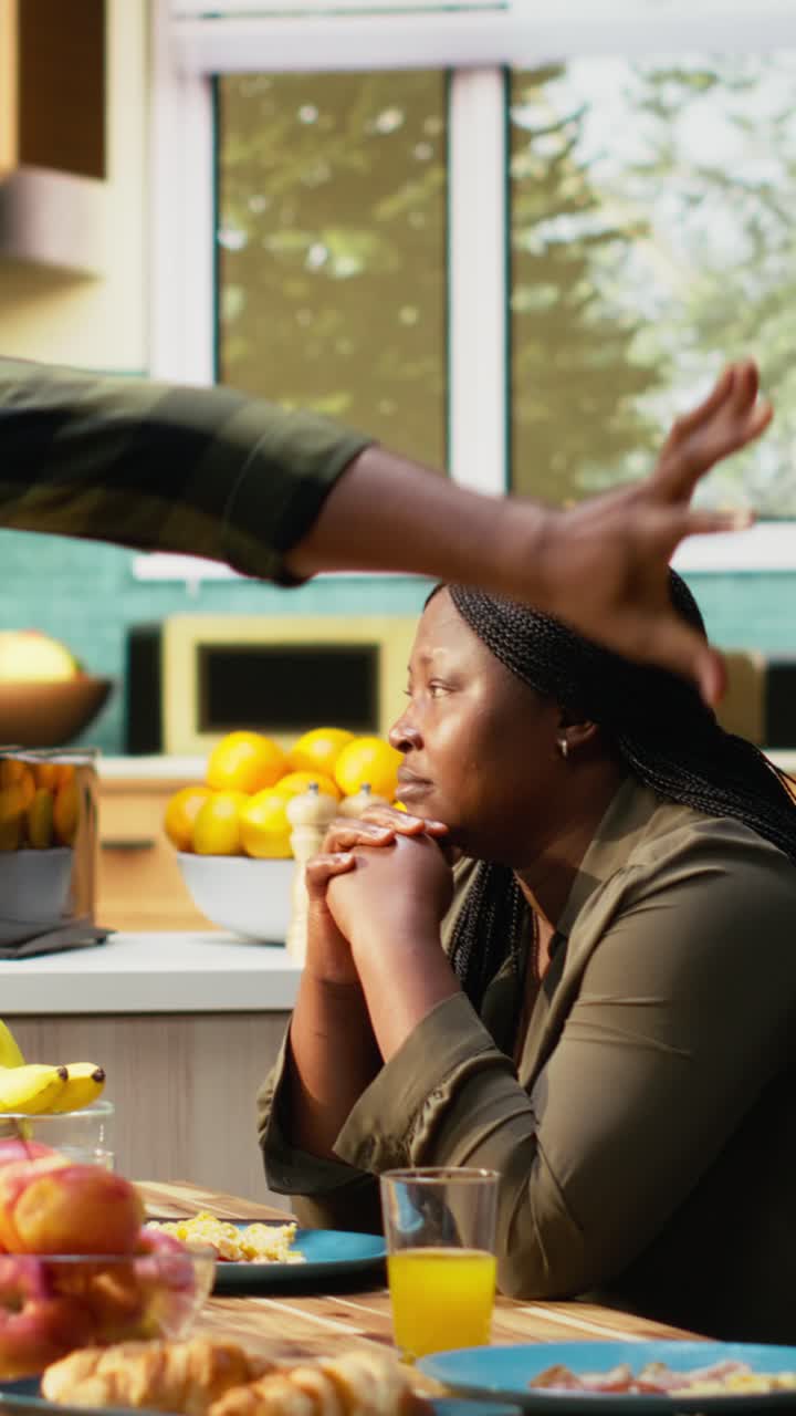 Vertical Video Black children playing around and fighting with food while mom ignores them