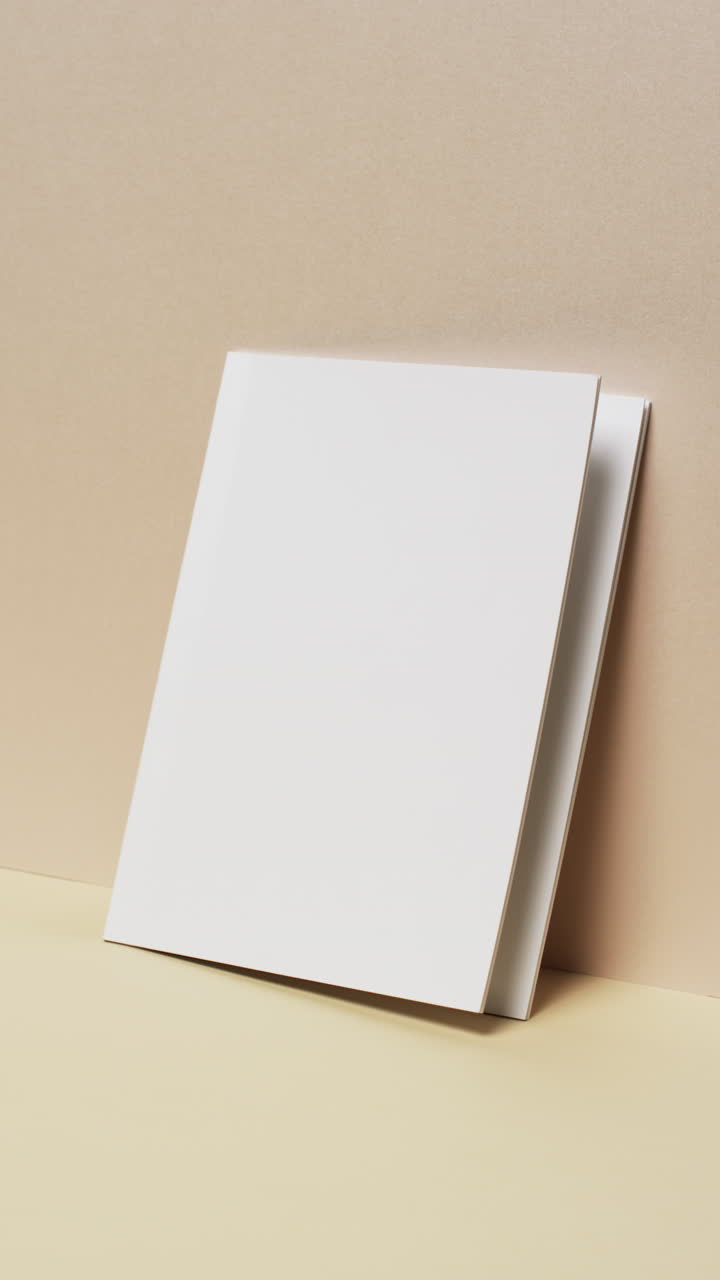 Vertical video of book with white blank pages and copy space on yellow background