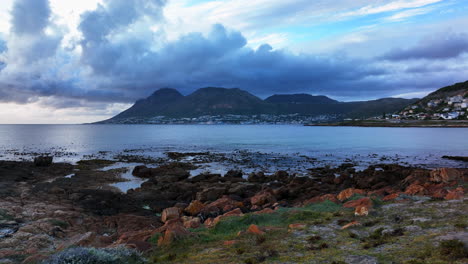 South-African-sunrise-sunset-Simon's-Town-drone-aerial-cinematic-Fish-Hoek-rugged-reef-coast-small-fishing-town-marina-city-stunning-summer-spring-deep-aqua-blue-ocean-train-tracks-slider-right-motion