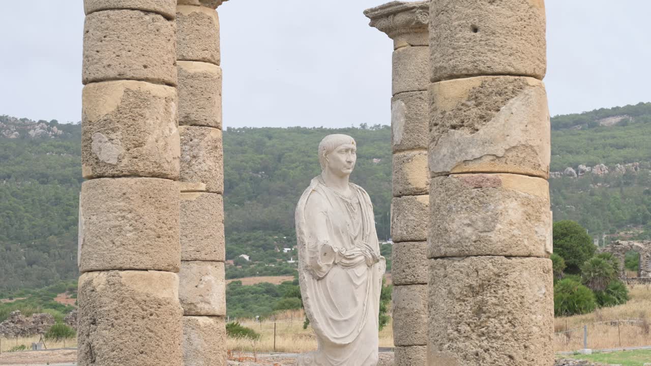 Togate statue of Emperor Trajan in Roman ruins of Baelo Claudia