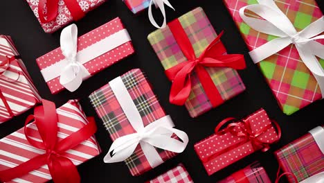 Top-view-of-wrapped-Christmas-presents-laid-on-the-black-background